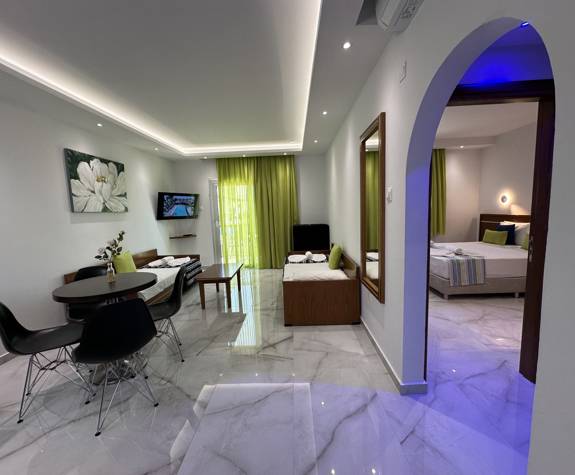 Loutsiana Hotel Deluxe One Bedroom Apt living room and table